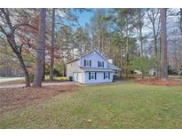 Two-story house with gray siding, attached garage, and a spacious lawn at 5385 Telford Ct, Powder Springs, GA 30127