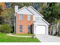 Charming two-story home with gray siding and brick accents at 894 Churchill Ct, Stone Mountain, GA 30083