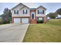 Two-story house with attached two-car garage and a brick facade at 8432 Browns Mill Trce, Stonecrest, GA 30038