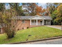 Brick ranch house with a covered porch and landscaped yard at 796 Vanderbilt Nw Ct, Atlanta, GA 30318
