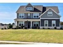 Two story home with gray siding, white trim, and a large front yard at 100 Leveret Rd, Locust Grove, GA 30248