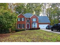 Brick two-story house with attached garage and manicured lawn at 4761 Habersham Way, Conyers, GA 30094