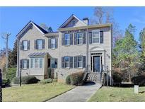 Brick front two-story home with a welcoming entrance and landscaping at 5958 Eagle Tiff Ln, Sugar Hill, GA 30518