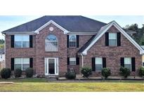 Brick two-story house with black shutters and a well-maintained lawn at 6476 Snowden Dr, Atlanta, GA 30349