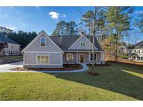 Two-story craftsman home with gray siding, brick accents, and a covered porch at 312 Brook Hollow Ln, Loganville, GA 30052