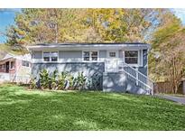 Newly renovated ranch home with gray siding, landscaping, and a spacious yard at 2190 Lang Sw Dr, Atlanta, GA 30315