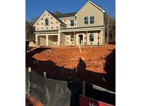 Two story house with a gray exterior, stone accents, and a two car garage at 217 Orwell Dr, Social Circle, GA 30025