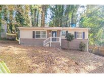 Brick ranch home with a landscaped yard and a welcoming front porch at 2196 Swallow Se Cir, Atlanta, GA 30315