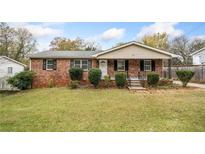 Brick ranch house with a large front yard and mature trees at 1085 Azalea Cir, Marietta, GA 30062