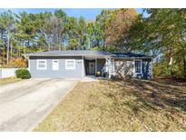 Gray house with stone accents, covered porch, and a spacious yard at 3512 Riverchase Knls, Decatur, GA 30034