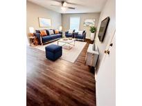 Bright living room with stylish navy blue furniture and hardwood floors at 6700 Roswell Rd # 13B, Atlanta, GA 30328