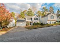 Two-story house with attached garage and landscaping at 6390 Alford Cir, Lithonia, GA 30058