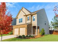 Two-story home with brick and siding exterior, two-car garage, and landscaping at 3113 Baylor Cir, Mcdonough, GA 30253