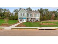 Two-story home with gray siding, brick accents, and a landscaped lawn at 236 Ruthe Cvs, Locust Grove, GA 30248