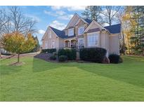 Two-story house with stone accents and landscaped lawn at 345 Devereux Downs, Roswell, GA 30075