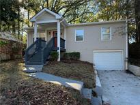 Charming ranch home with gray stairs, red door and attached garage at 3152 Delmar Nw Ln, Atlanta, GA 30311