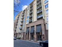 Modern multi-story building with brick and light-colored siding, balconies, and covered entryway at 711 Cosmopolitan Ne Dr # 426, Atlanta, GA 30324