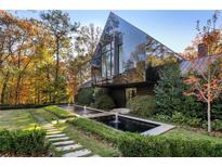 Modern home with black exterior, long water feature, and stone pathway at 2716 Ridgewood Nw Rd, Atlanta, GA 30327