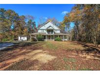 Two story house with wrap around porch and large backyard at 90 Wiley Dr, Douglasville, GA 30134