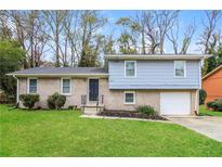 Brick ranch house with attached garage and landscaped lawn at 3900 Emerald North Dr, Decatur, GA 30035
