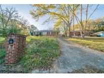 Brick ranch home with driveway and mature trees at 2693 Larkspur Se Dr, Atlanta, GA 30316