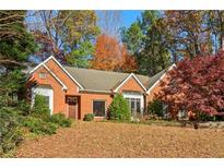 Brick house with a large front yard and mature trees at 230 Wessex Ct, Atlanta, GA 30328