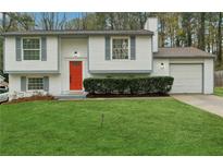 Charming house with a bright red door and well-manicured lawn at 1277 Muirforest Dr, Stone Mountain, GA 30088