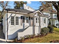Charming renovated brick home with a welcoming front porch and landscaped lawn at 2044 Fairhaven Cir, Atlanta, GA 30305