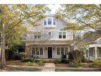 Two story craftsman style home with gray siding, stone accents, and a covered porch at 9150 Selborne Ln, Chattahoochee Hills, GA 30268