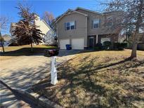 Two-story house with attached garage and landscaping at 2754 Topaz Rd, Riverdale, GA 30296