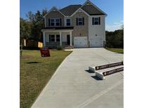 Two-story home with gray siding, large driveway, and a three-car garage at 504 Overlook Rd, Covington, GA 30052