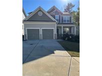 Two-story house with gray siding, two-car garage, and manicured lawn at 2013 Chesley Dr, Austell, GA 30106