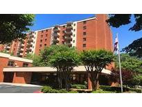 Brick apartment building with landscaped grounds and ample parking at 300 Johnson Ferry Rd # B802, Atlanta, GA 30328
