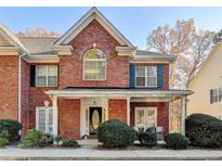 Brick front exterior of charming two-story home with covered porch at 2075 Pine Tree Dr # A4, Buford, GA 30518