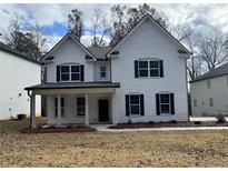 Charming two-story home with white siding, black shutters, and a covered front porch at 3964 Riverchess Lot 157 Dr, Atlanta, GA 30331