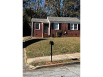 Brick ranch house with a well-maintained lawn and a black mailbox at 1777 Cahoon Sw St, Atlanta, GA 30310