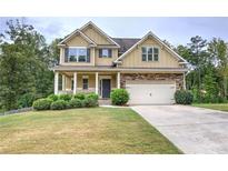 Two-story house with stone accents, a large front yard, and a two-car garage at 138 Gorham Gates Dr, Hiram, GA 30141