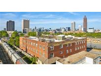 Aerial view of a brick building with city skyline in background at 490 Marietta St # 307, Atlanta, GA 30313