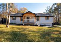 Charming one-story home with white siding, wood accents, and a spacious front porch at 5563 Austell Road #A, Austell, GA 30106