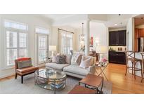 Bright living room with hardwood floors, neutral-toned furniture, and large windows at 50 Biscayne Nw Dr # 6117, Atlanta, GA 30309