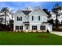 Two-story house with gray siding, black shutters, and a large front yard at 1462 Stephens View Dr, Loganville, GA 30052