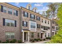 Brick townhome with multiple levels and dormers, showcasing a well-maintained exterior at 2022 Talmai Dr, Snellville, GA 30078