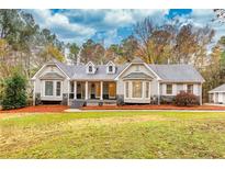 Ranch style home with stone accents and a spacious lawn at 4120 Grady Smith Rd, Loganville, GA 30052