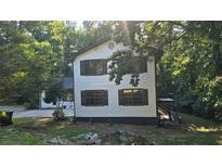 Two-story house with white siding, dark trim, and a deck at 409 Arbor Ridge Dr, Stone Mountain, GA 30087