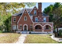 Brick home with a large front porch and mature landscaping at 1225 Clifton Rd, Atlanta, GA 30307