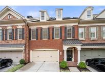 Brick townhouse with 2-car garage, inviting front entrance, and well-manicured landscaping at 2252 Edgartown Se Ln # 2, Smyrna, GA 30080