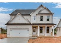 Two-story white brick home with a gray roof, front porch, and attached two-car garage at 2870 S Waterworks Rd, Buford, GA 30518