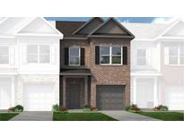 Brick townhouse exterior with 2-car garage and landscaping at 273 Dupont Dr # 37, Cartersville, GA 30121