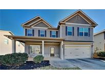 Two-story house with gray siding, a large front porch, and a two-car garage at 2156 Villa Spring Ct, Dacula, GA 30019