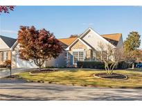 Tan house with stone accents and a neatly landscaped yard at 850 Melbourne Trl, Alpharetta, GA 30009